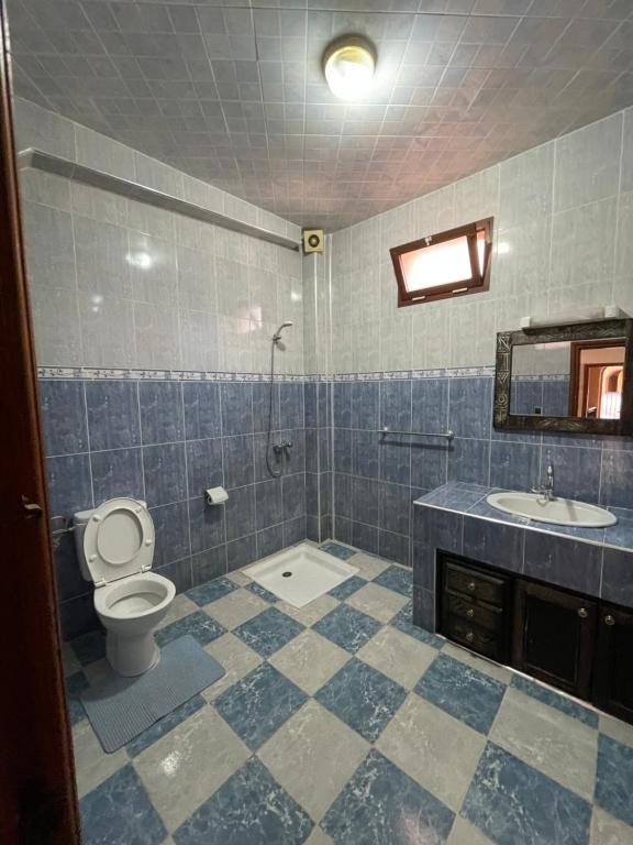 a bathroom with a toilet and a sink at Sunny Surf Riad apartment in Tamraght in Agadir