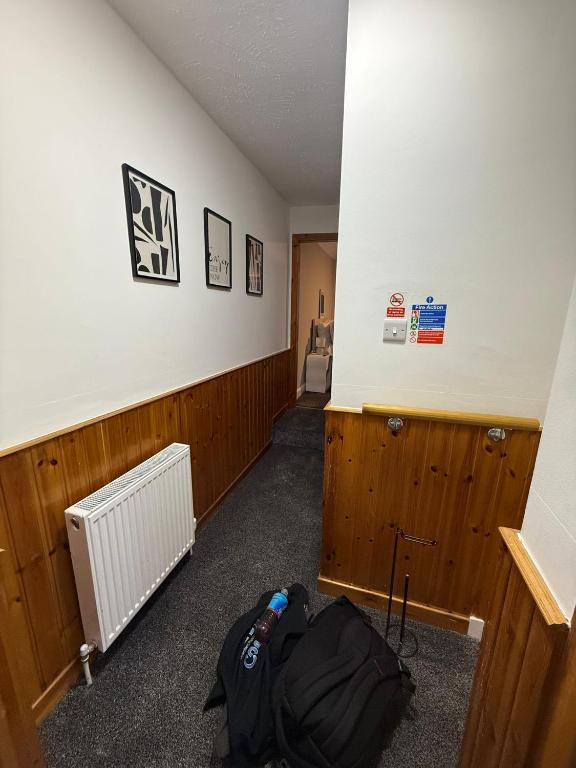 a room with a room with a backpack and a hallway at Vacant Nests Ivy Cottage 3BR Wi-Fi in Banton