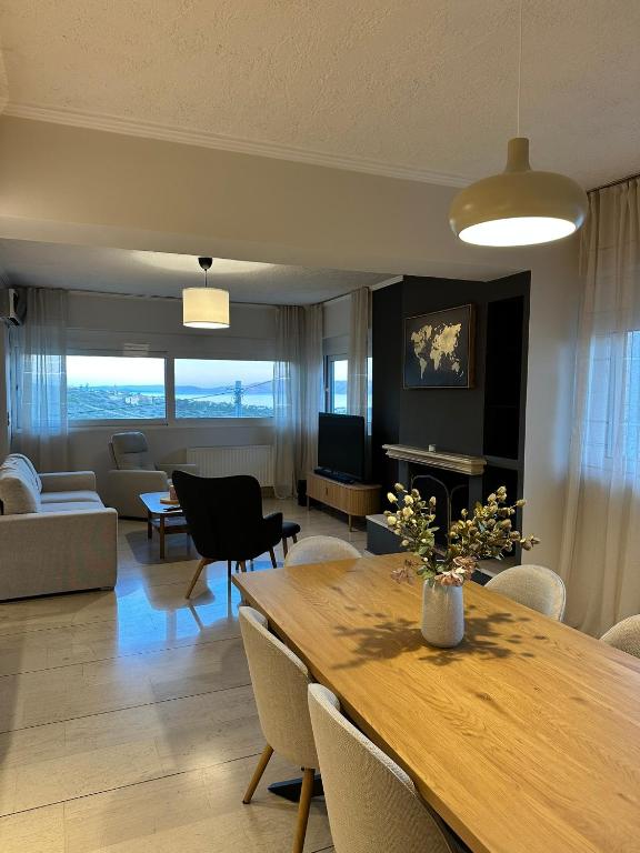 a living room with a wooden table and a couch at Aegean Hill Skyview in Pikérmion