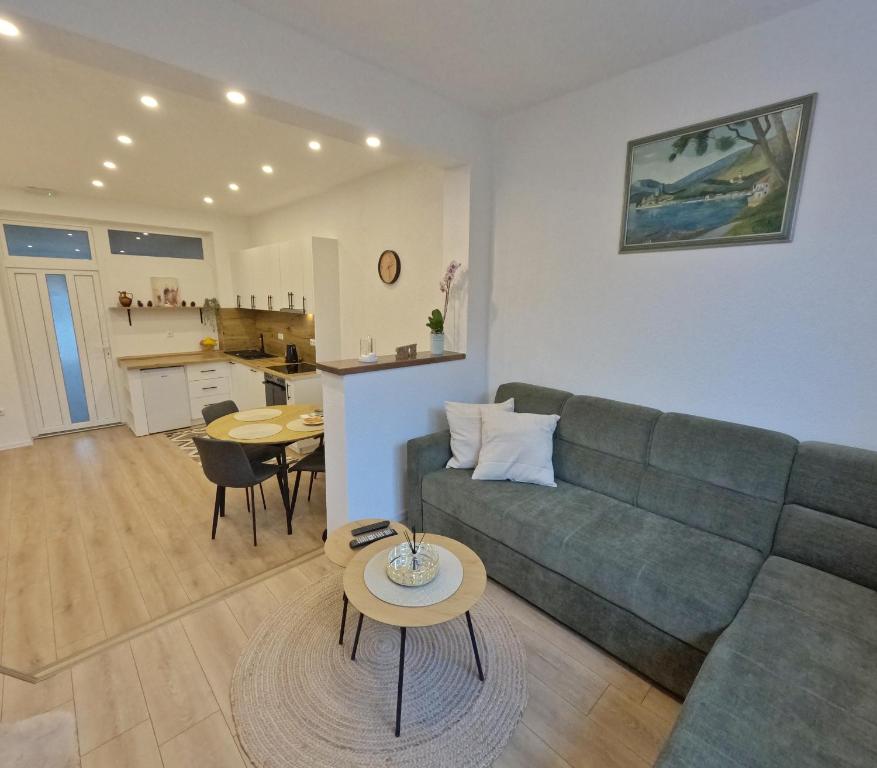 a living room with a couch and a table at Apartman Anita in Kupres