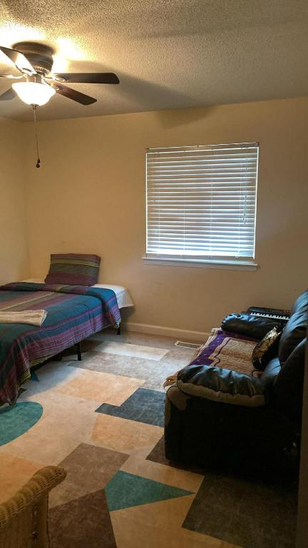 a bedroom with two beds and a ceiling fan at Cozy, private room near Virginia Beach town center in Virginia Beach