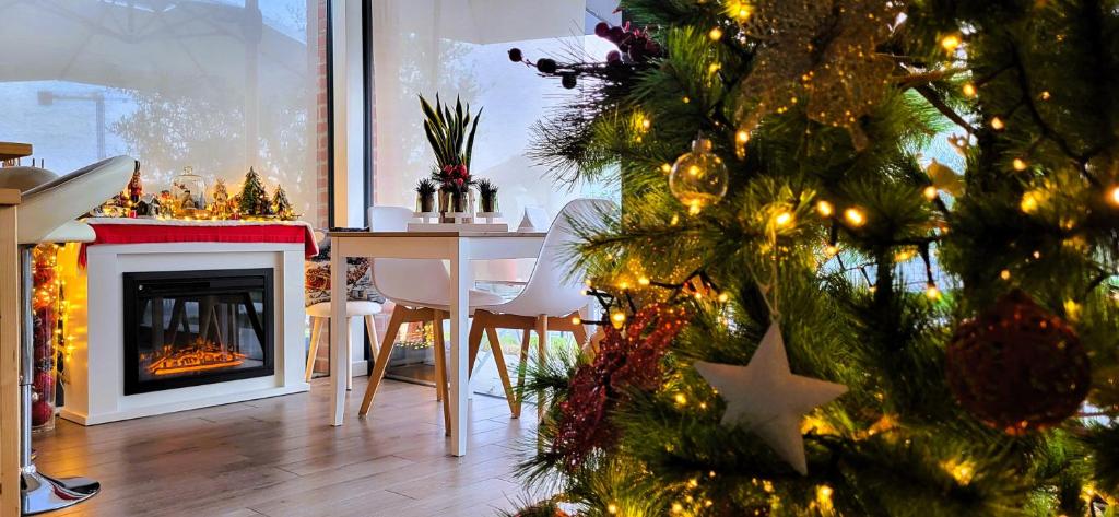 a christmas tree in a living room with a fireplace at Stella del Garda in Lazise