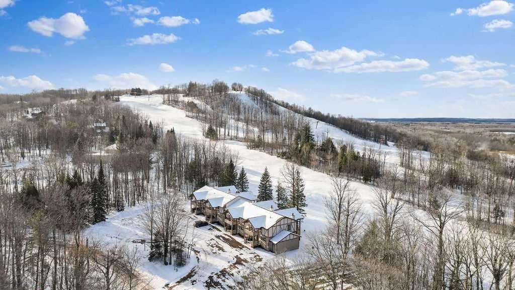 eine Luftaufnahme eines Hauses im Schnee in der Unterkunft Cozy Ski Lodge Condo I Alpen Villas at Powderhorn Mountain in Bessemer
