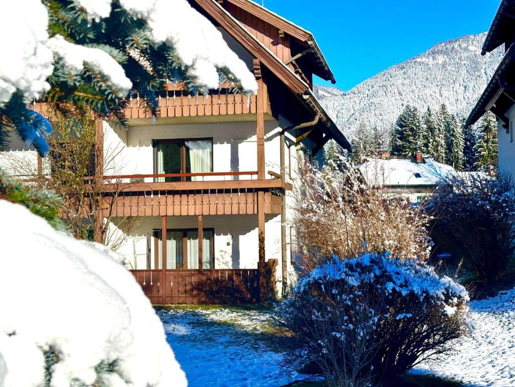 a house in the snow with snow covered trees at Alpenblick Apartment in Hermagor