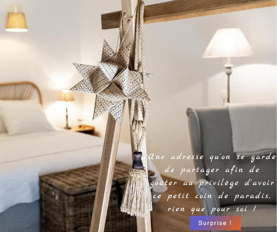 a christmas star on a bed in a bedroom at La petite madeleine - Chambre d'hôtes & spa in Burgy