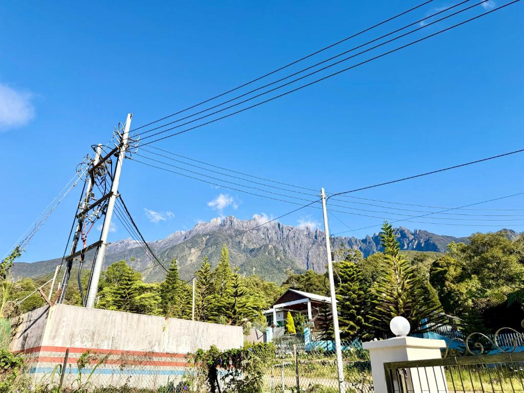a mountain in the distance with power lines at Deco Home The Oasis Mesilau at Kundasang in Kundasang