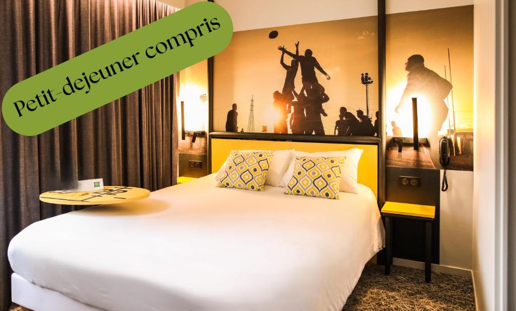 a bedroom with a bed with a poster on the wall at Ibis Styles Clermont-Ferrand République in Clermont-Ferrand