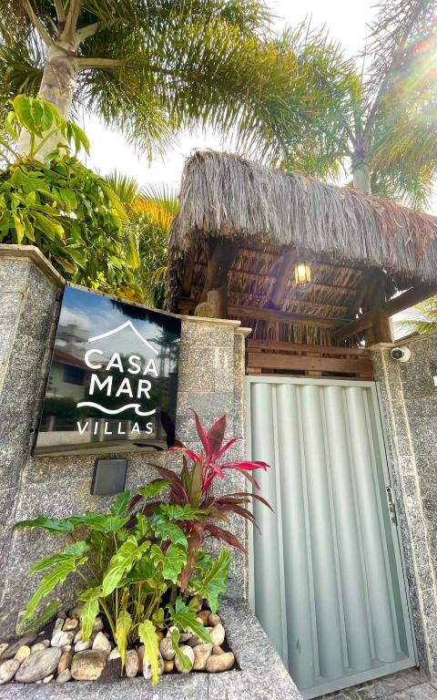 a gate to a carribean mar villas with a garage at Casa Mar Villas in Florianópolis