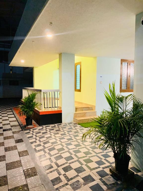 a lobby with potted plants in a building at Serene Retreat in Varkala