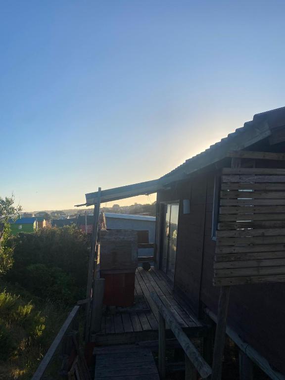 a house with a deck with a view of the water at Cabaña in Punta Del Diablo