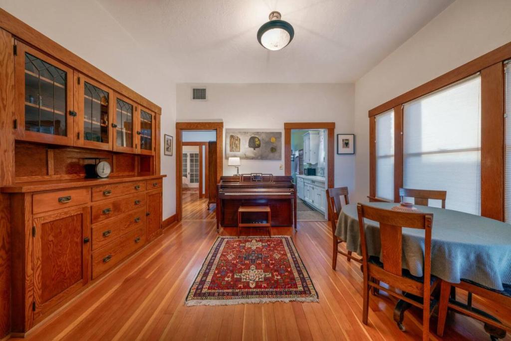 a bedroom with a desk and a table and a piano at N 1st Ave in Tucson