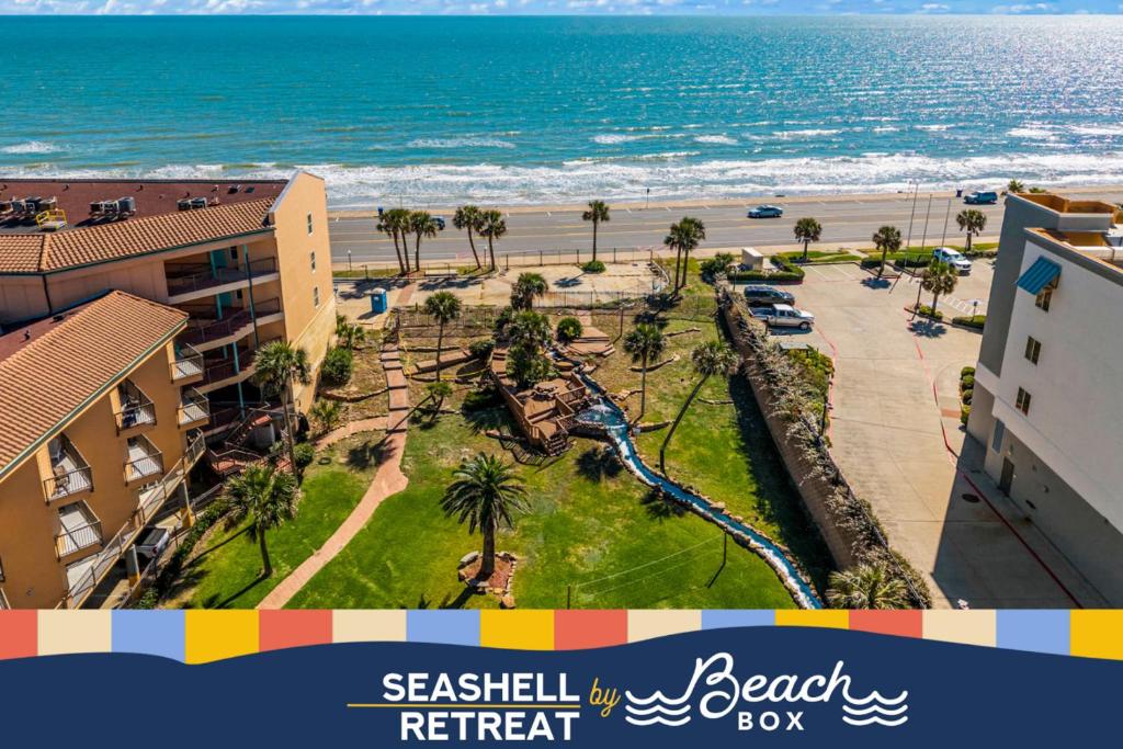 a view of the beach from the balcony of a resort at Seashell Retreat - Beachfront Condo with Pools and Cabanas in Galveston