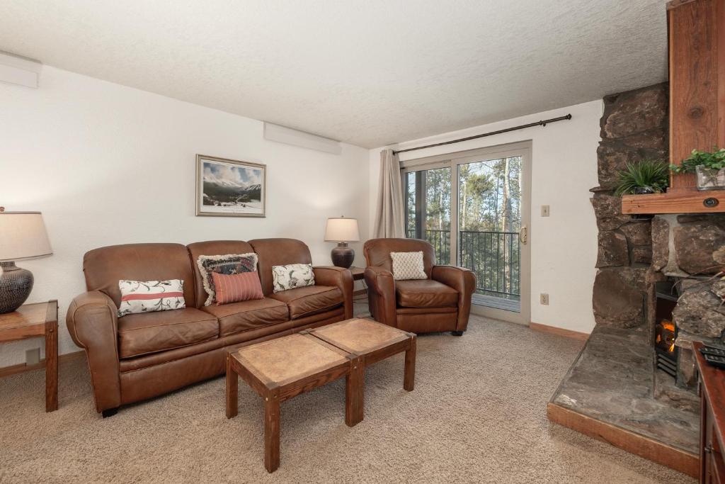 a living room with two couches and a fireplace at Beaver Village Unit #0724 in Winter Park