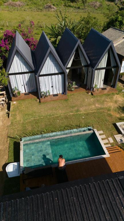 an overhead view of a house with a swimming pool at Hop Village in Praia do Rosa