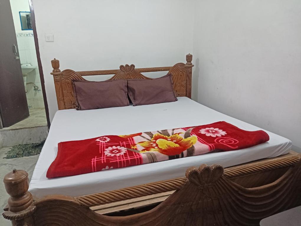 a bed with red blankets and pillows on it at Comfi Stay Hotel Bhopal in Bhopal