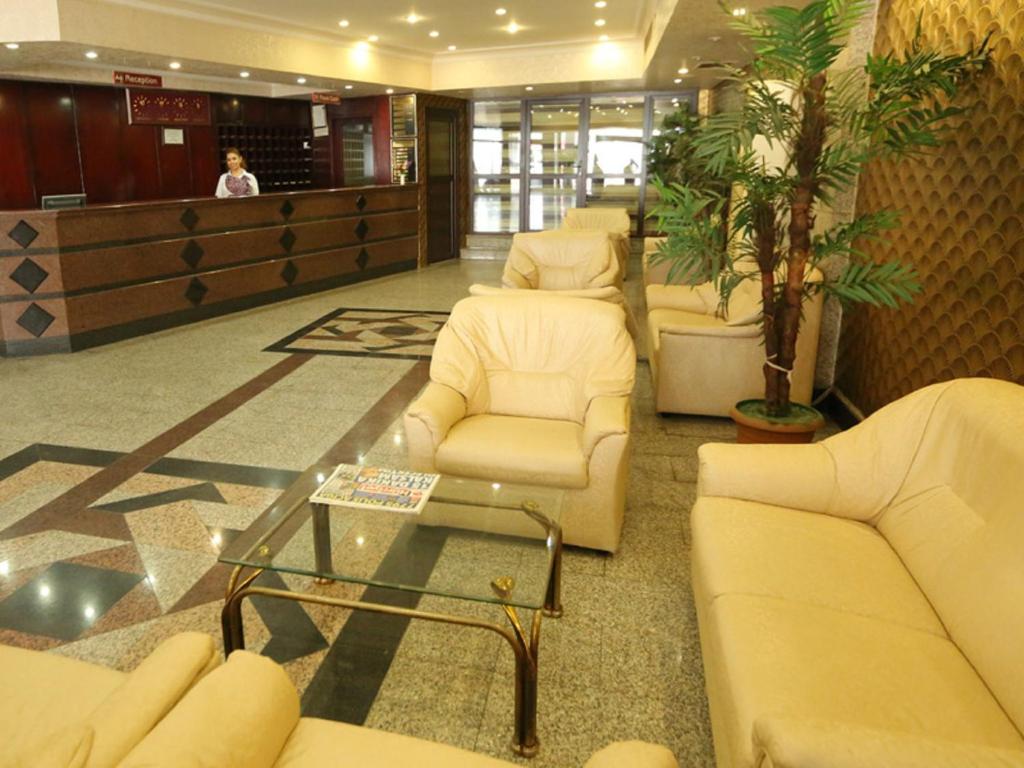 a waiting room with white couches and a table at Kayalar Hotel in Antalya