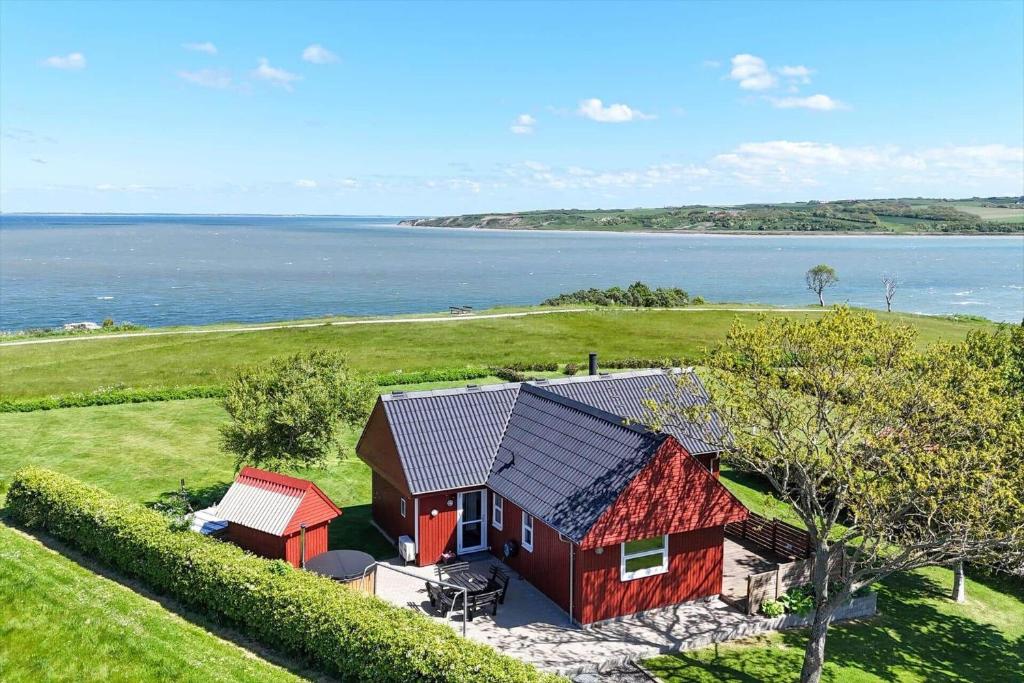 an aerial view of a red house next to the ocean at G421-Lemvig-Gyvelvej-21 in Lemvig
