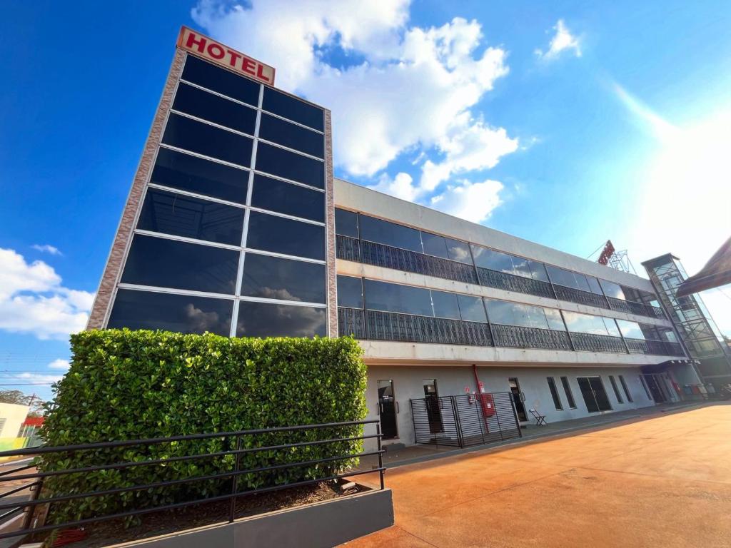 a building with a sign on the front of it at Hotel Inter Alexandria in Cândido Mota