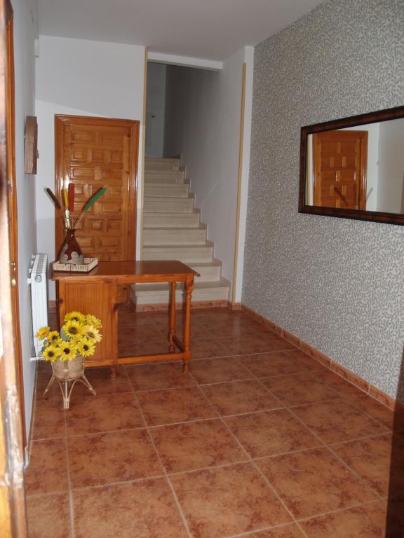 a living room with a table and a staircase at Apartamento2 San Cristobal cerca de Cuenca in Colliguilla