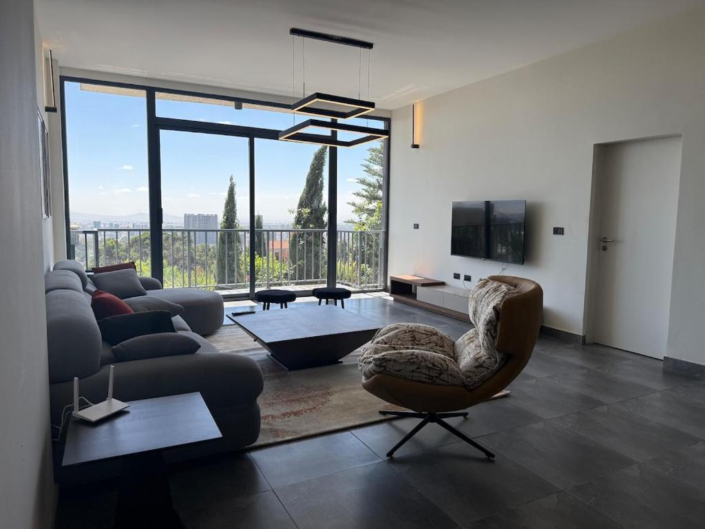 a living room with a couch and a chair at Chic & Cozy Designer Space 1A in Addis Ababa