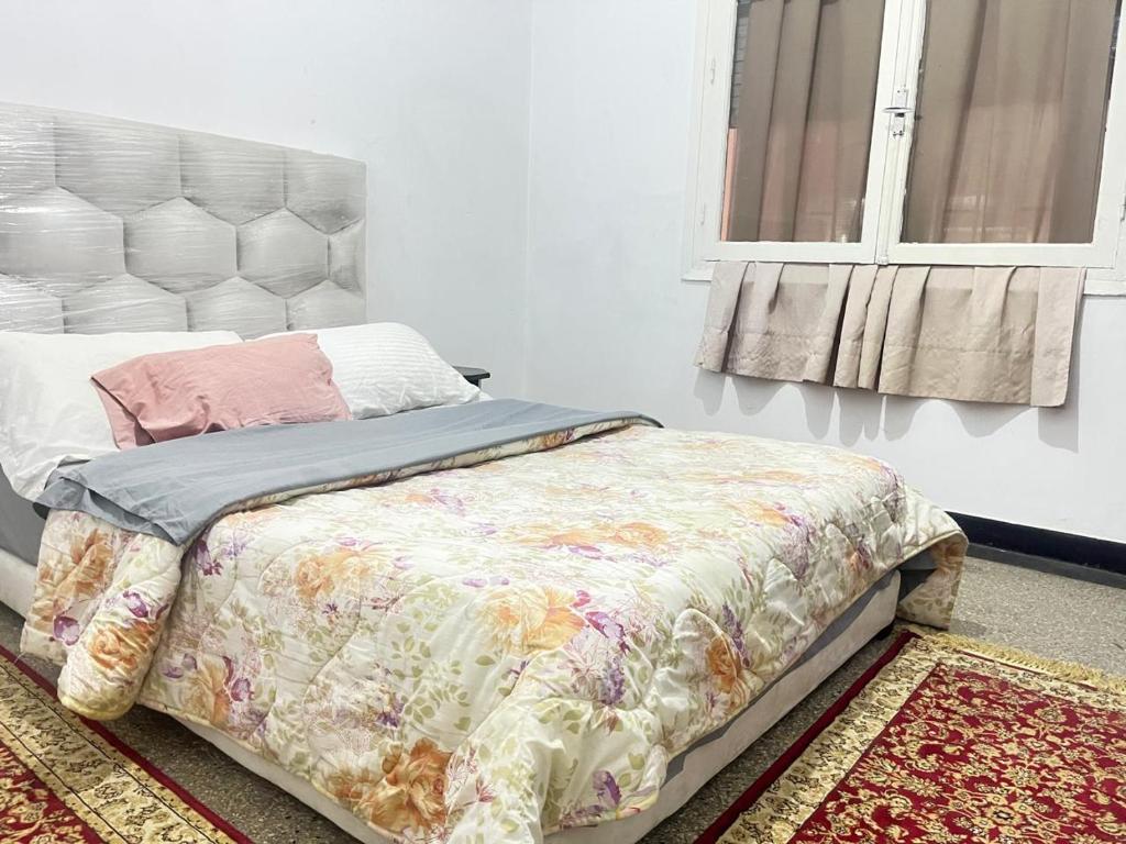 a bedroom with a bed and a window at Agdal apart in Rabat