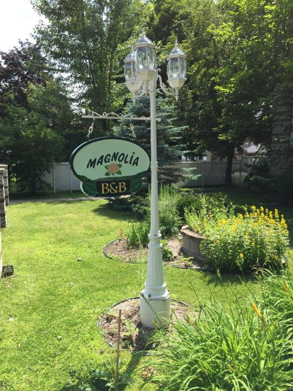 a street light with a sign on it in a yard at Magnolia B&B in Granby