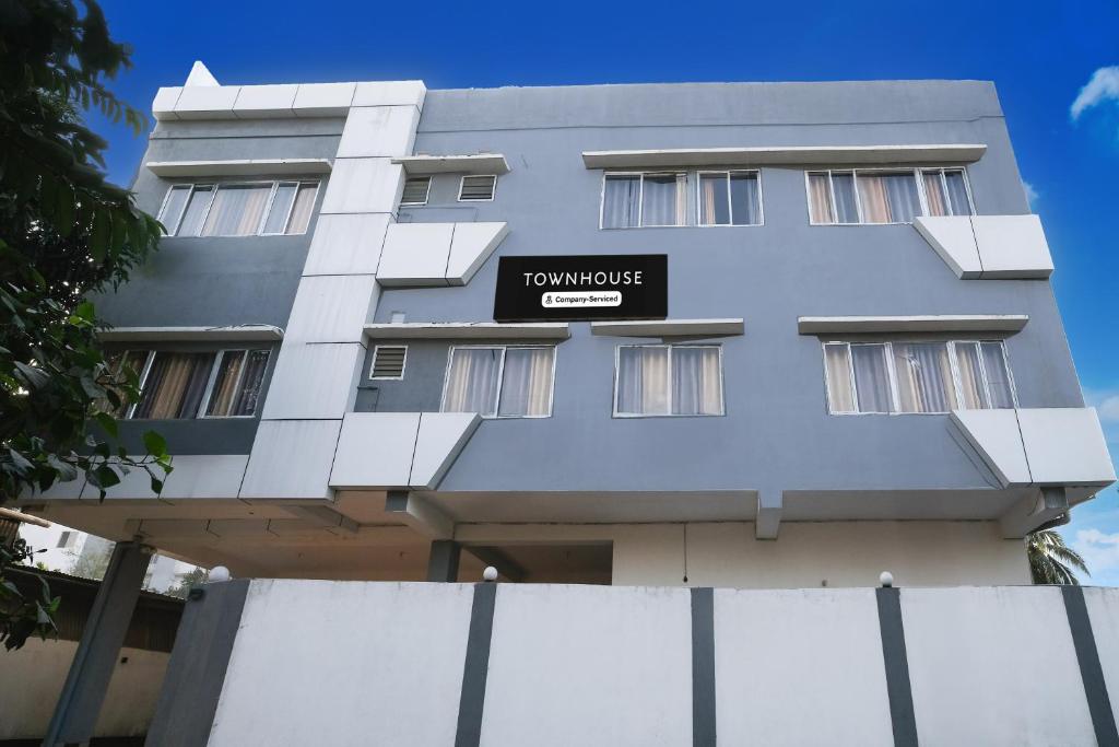 a building with a sign that reads tamponga at Super Townhouse Lalmati National Highway 27 Formerly The Pinnacle Inn in Dispur