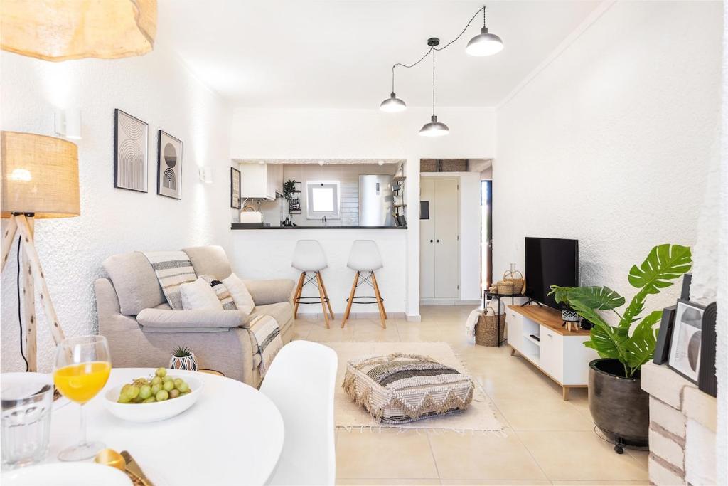 a living room with a couch and a table at Manelinha Apartment - cozy apartment with pool and beach in Quarteira