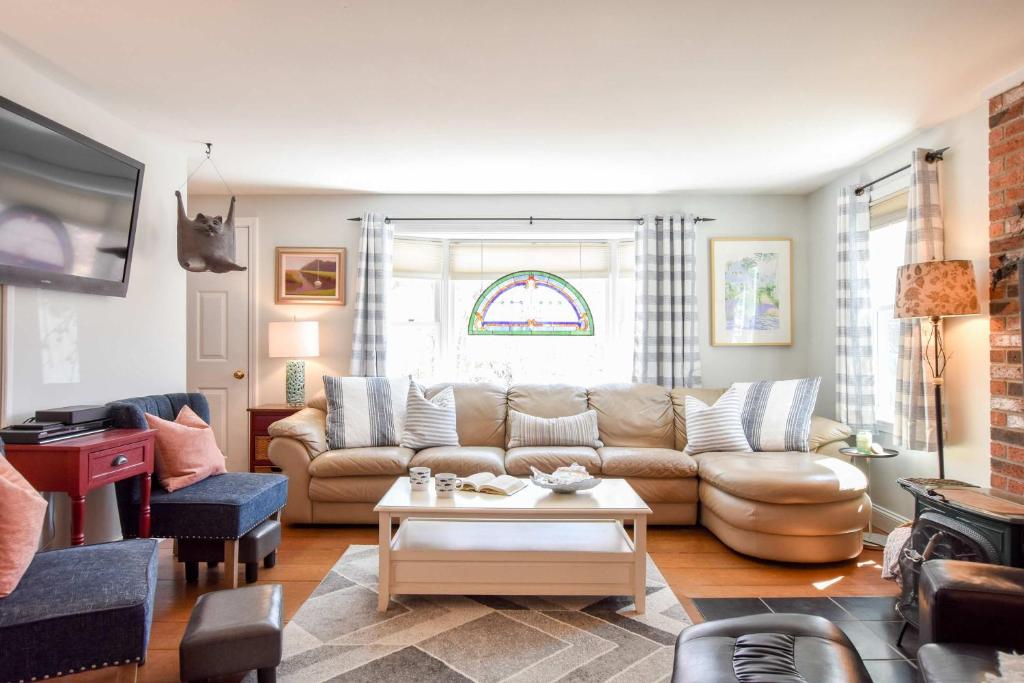 ein Wohnzimmer mit Sofa und Tisch in der Unterkunft 5 Min to Beach Yard w Fire Pit in Wellfleet