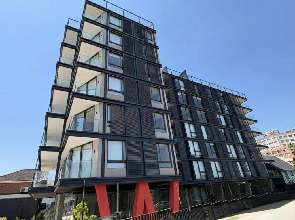 a tall black building with red bows at At Home Alonso in Santiago