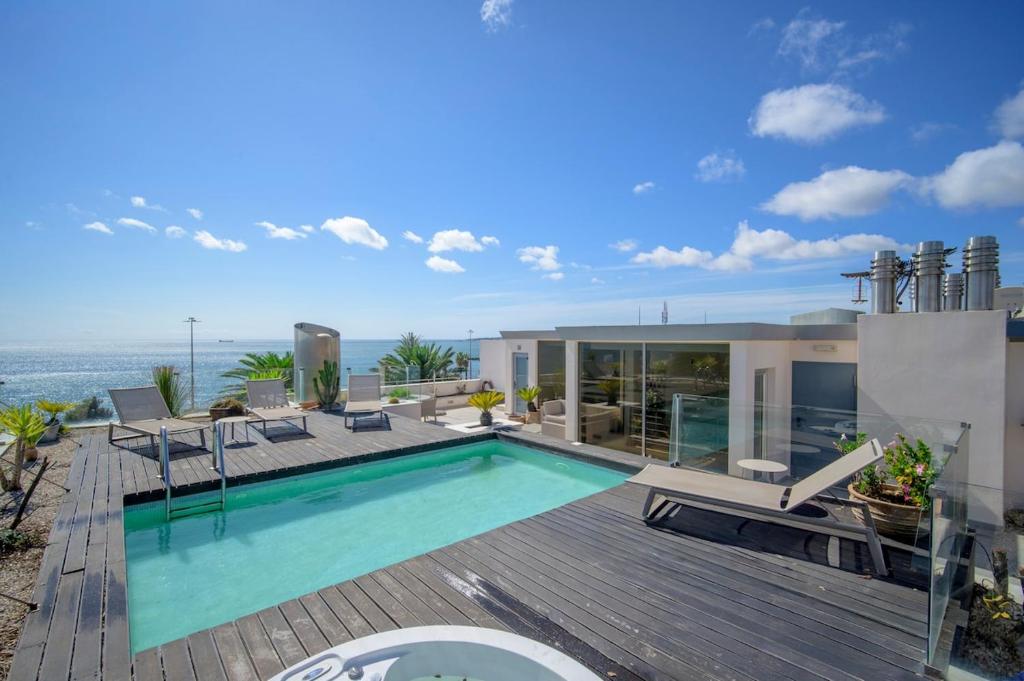 a house with a swimming pool on a wooden deck at Bafureira 22 Rooftop in Parede