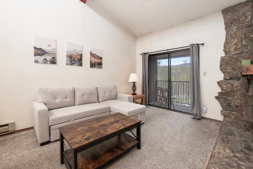 a living room with a couch and a table at Beaver Village Unit #0834 in Winter Park