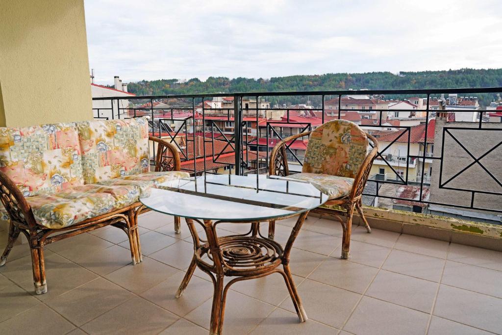 a balcony with two chairs and a table and a view at Central Grevena Retreat with Mountain Views in Grevena