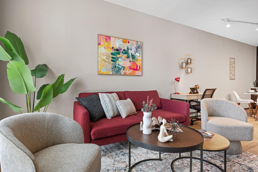 a living room with a red couch and chairs at Irvine Luxury Living | Pool, Gym & Prime Location in Irvine