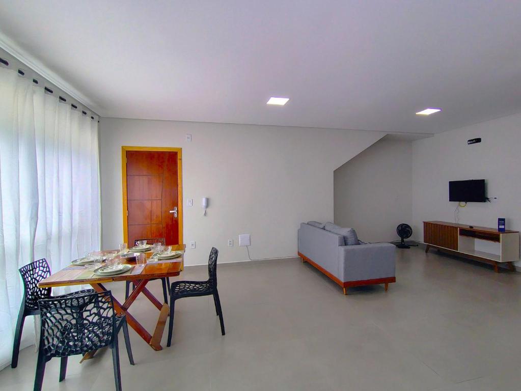 a living room with a table and chairs and a couch at Apto c/ churrasqueira a 190m da Praia MBU0102 in Barra Velha