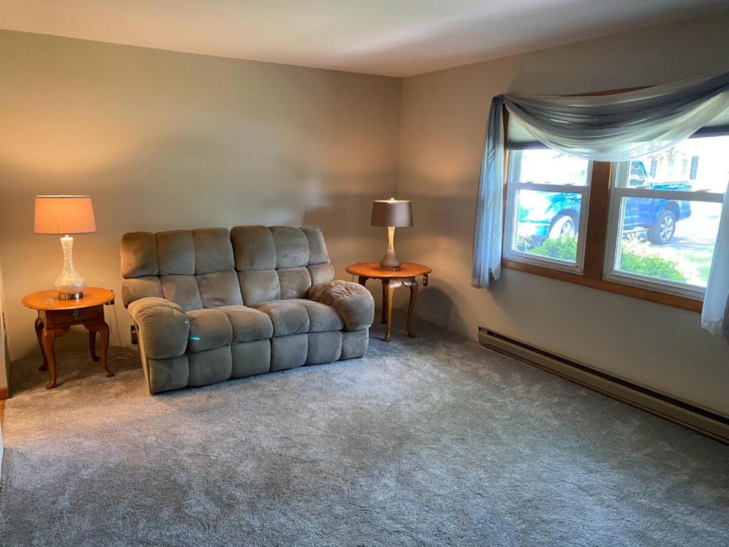 a living room with a couch and a window at 2 bedroom home in a quiet neighborhood in Plattsburgh