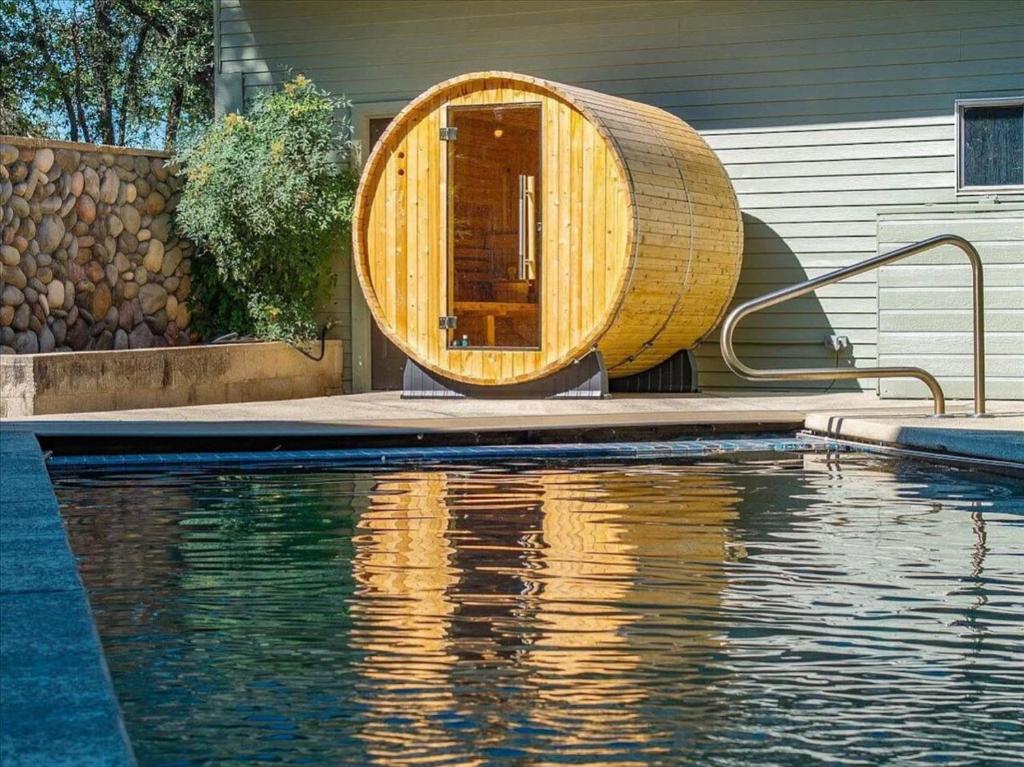 a wooden tub sitting next to a swimming pool at Montgomery Ranch - Main House in Redding
