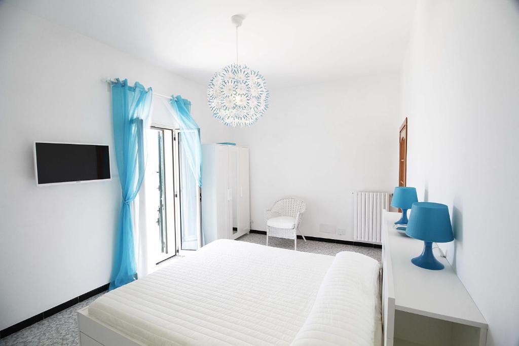 a white bedroom with a bed and a window at Casa Camilla in Monopoli