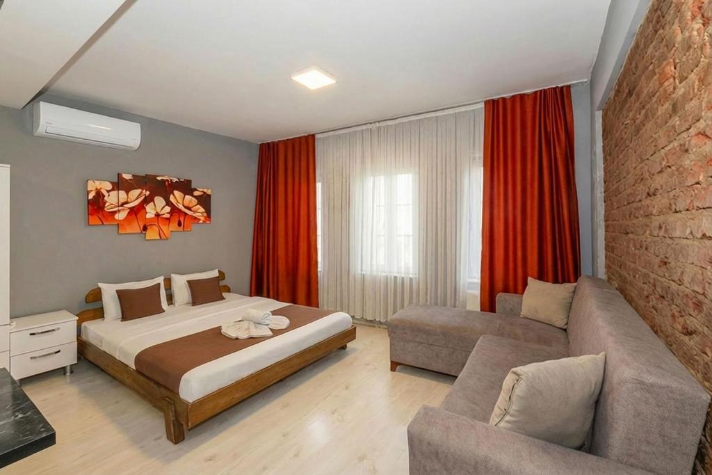 a bedroom with a bed and a couch in a room at Lion Apart Hotel Taksim in Istanbul