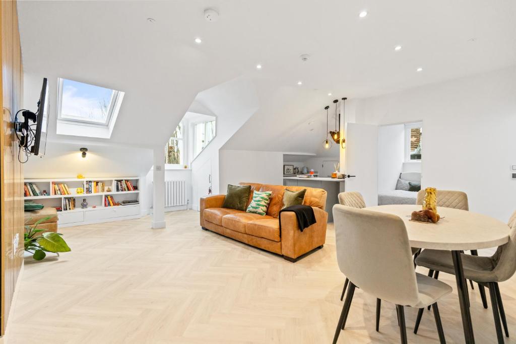 a living room with a couch and a table at Luxury modern 1 bed between Hampstead and Camden in London