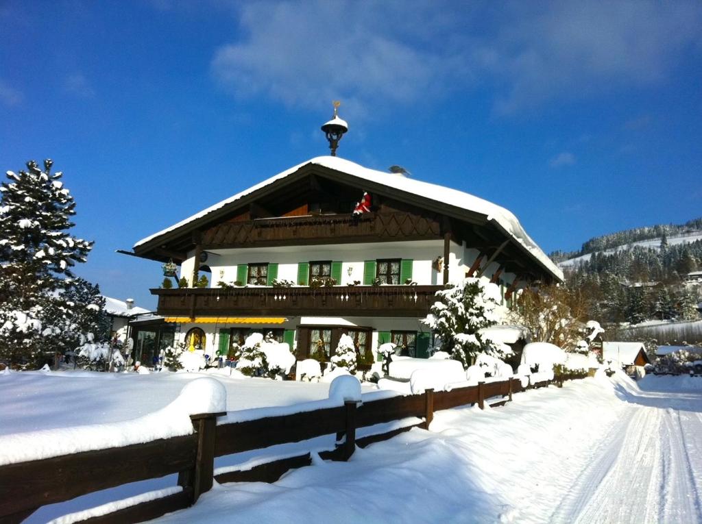 a large building with snow on the ground at Apartmenthaus Der Johanneshof - tolle Lage nah am See in Schliersee