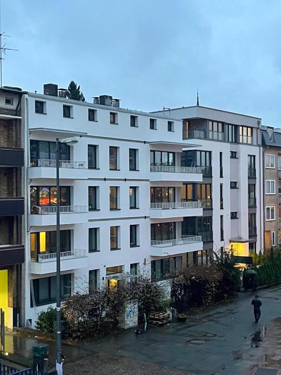 a white apartment building with a lot of windows at Milano Apartment in Hamburg