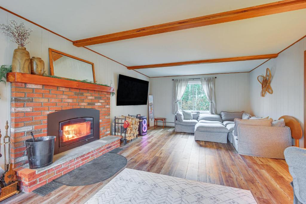 a living room with a brick fireplace and couches at 4 Mi to Bromley Mtn Family-Friendly Retreat! in Landgrove Town Center