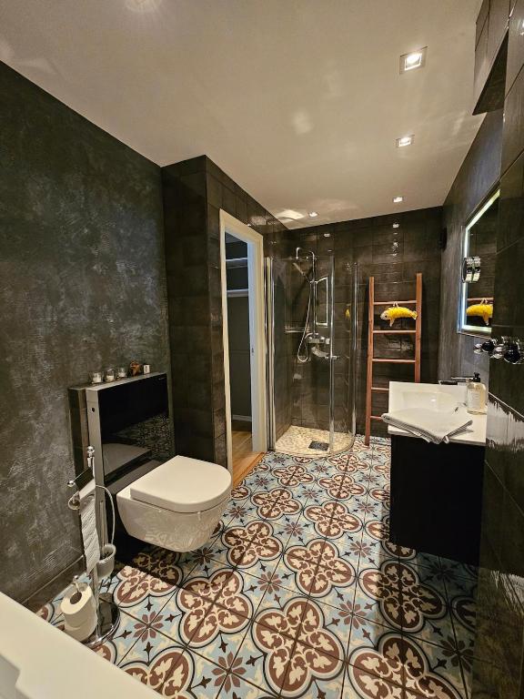 a bathroom with a toilet and a sink and a shower at Downtown apartment in Svolvær in Svolvær