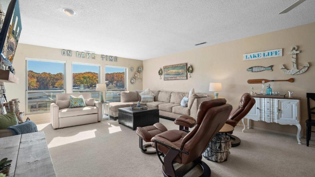 a living room with a couch and chairs at Easy Breezy - Lakefront for 6 in Sunrise Beach