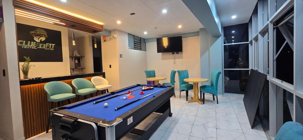 a pool table in a room with a bar at Hotel gym club33 in Huancayo