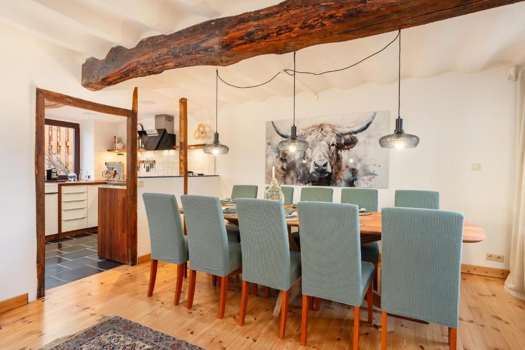 a dining room with a table and chairs at Zum Alten Kuhstall - Großes Landhaus mit XXL Sauna & Kamin in Lontzen