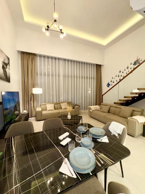 a living room with a table and a couch at 3 bedrooms villa with own pool! in Pano Dheftera