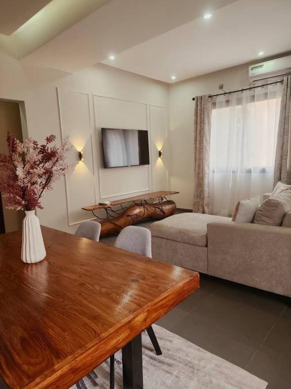 a living room with a table and a couch at La Trêve Sacrée - Dakar mermoz sacrée cœur in Dakar