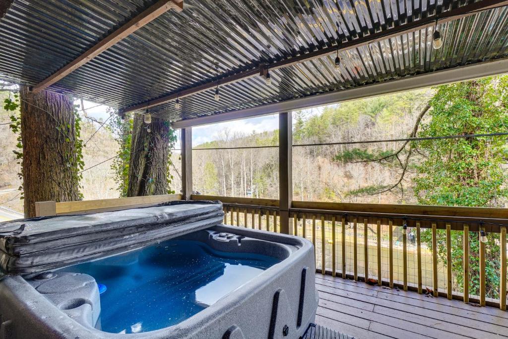 a hot tub on a deck with a large window at Hot Tub, Trails, Views! Little River Retreat in Sunshine